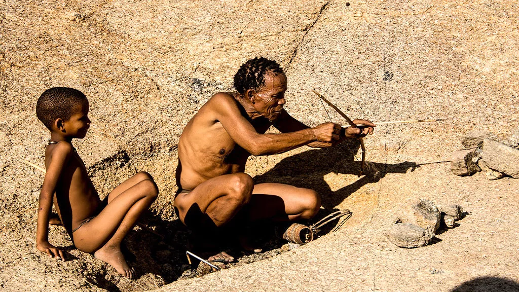 Two San Bushmen show people how they hunt