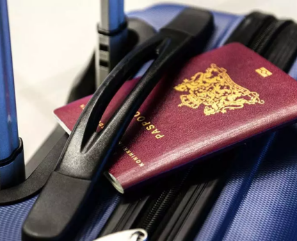 13_A-blue-travel-bag-with-a-UK-passport-tucked-under-the-handle