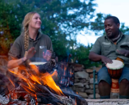 View-of-staff-and-guests-around-a-fire